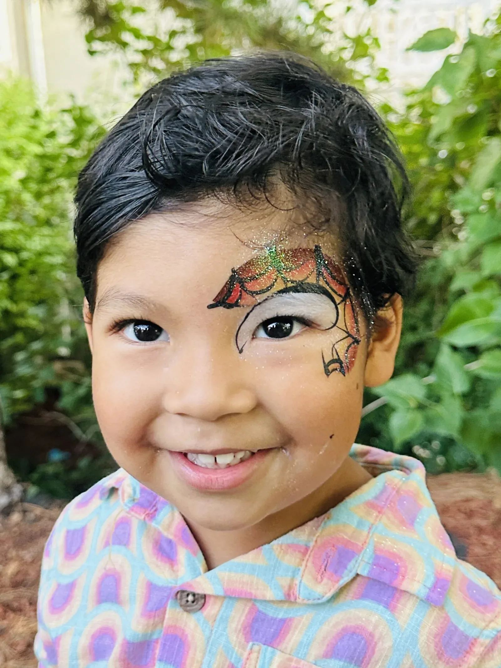 Child with dragon cheek art face painting.