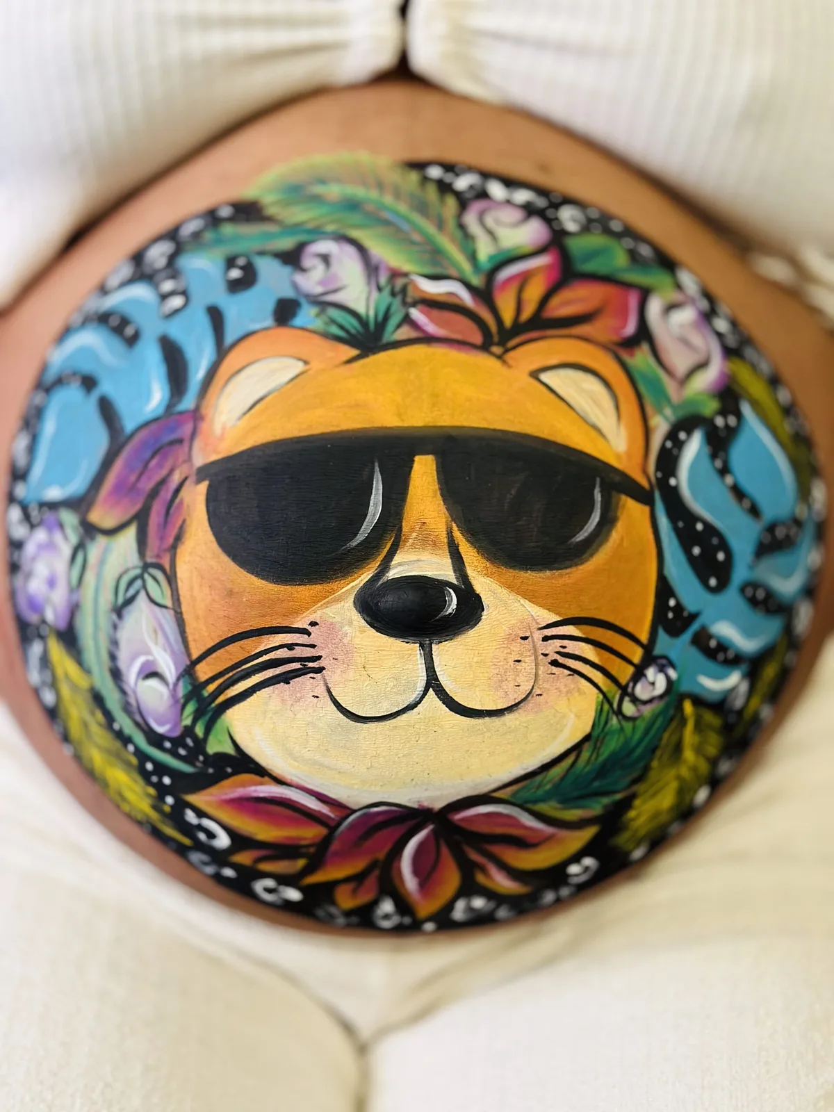 Pregnancy belly painting with a cool cat wearing sunglasses.